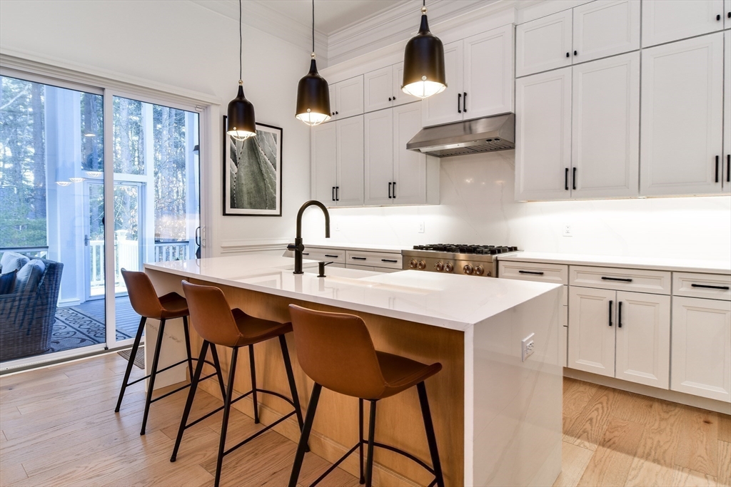 16 Barnes Boulevard, Unit 16 Hudson, MA 01749 - Photo 6 of 42 a kitchen with a sink a stove and chairs