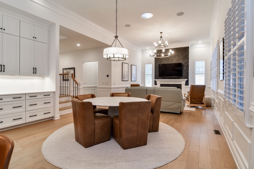 16 Barnes Boulevard, Unit 16 Hudson, MA 01749 - Photo 9 of 42 a living room with couches a flat tv screen and a chandelier
