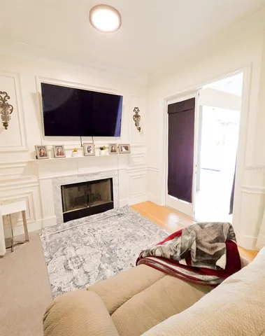 a view of a bedroom with wooden floor and a bathroom