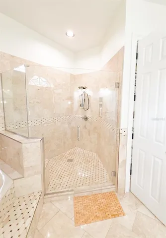 a bathroom with a glass shower door