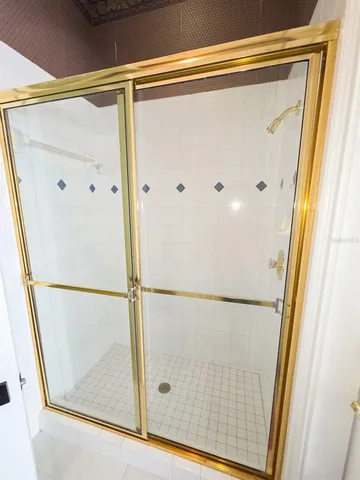 a spacious bedroom with a bed and a dresser with mirror