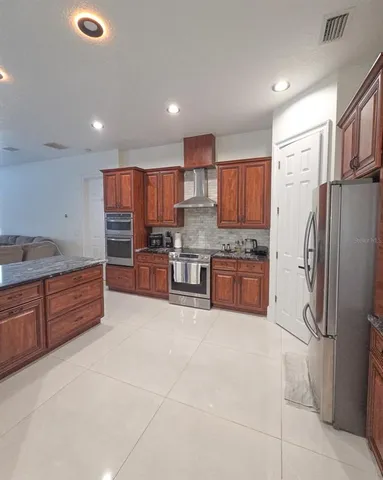 a bedroom with a bed and a chair