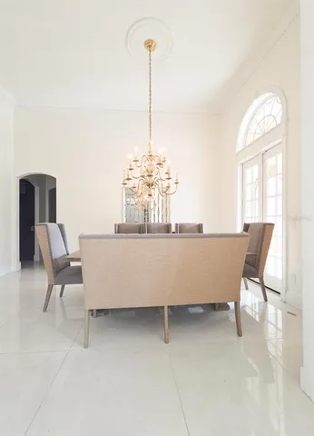 a living room with furniture and large windows