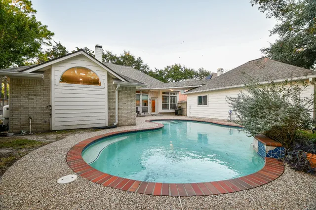 a view of a house with swimming pool and porch