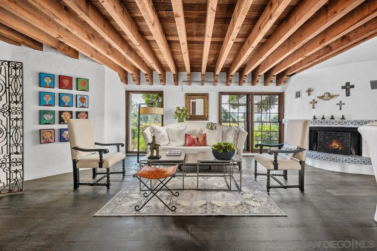 17507 Los Morros Rancho Santa Fe, CA 92067 - Photo 12 of 60 a living room with furniture a fireplace and a chandelier