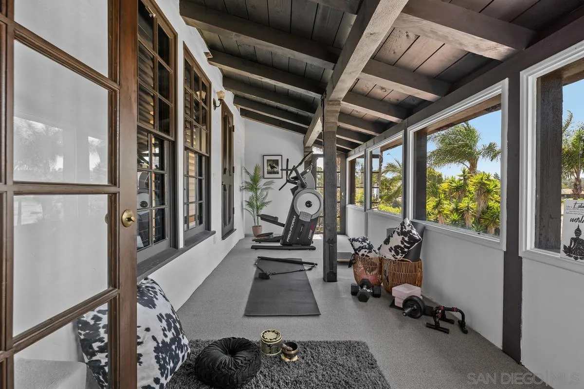 17507 Los Morros Rancho Santa Fe, CA 92067 - Photo 42 of 60 a room with gym equipment and a large window
