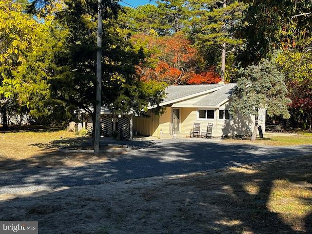 583 Tabernacle Road Medford, NJ 08055 - Photo 4 of 36 a view of a white house next to a yard with a large tree
