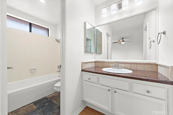 a bathroom with a sink and a mirror with bathtub