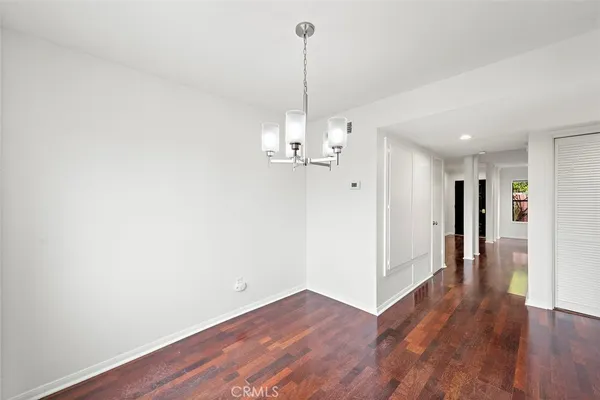 a view of a room with wooden floor and window