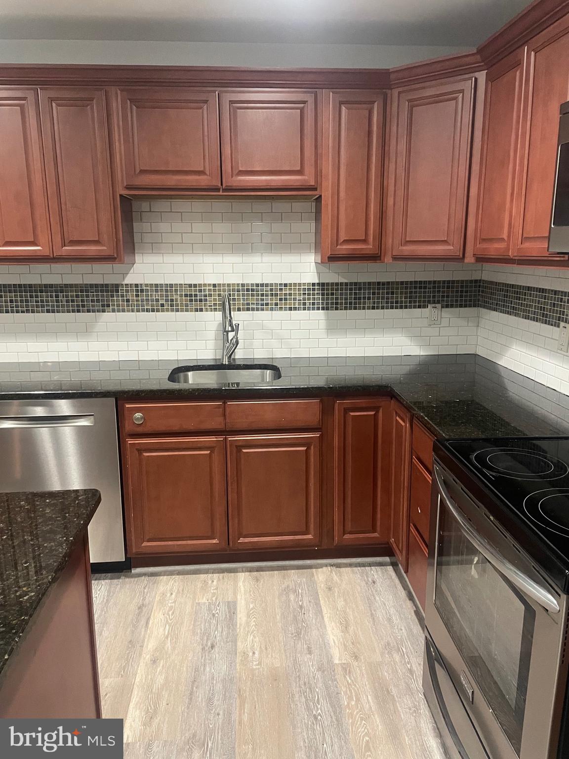 1300 Shadyside Road Downingtown, PA 19335 - Photo 16 of 17 a kitchen with stainless steel appliances granite countertop a sink stove and cabinets