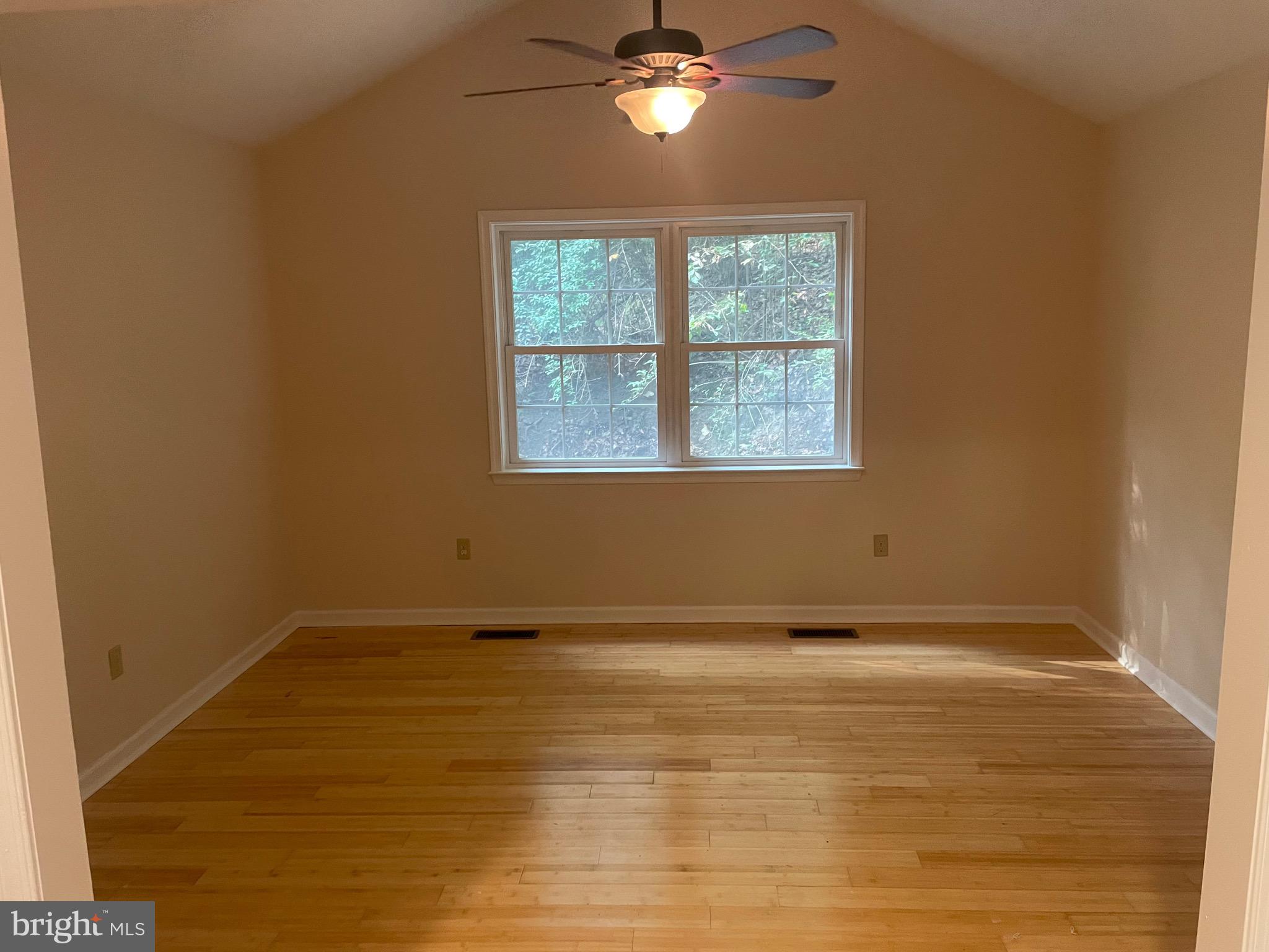 1300 Shadyside Road Downingtown, PA 19335 - Photo 5 of 17 a view of an empty room with wooden floor and a window