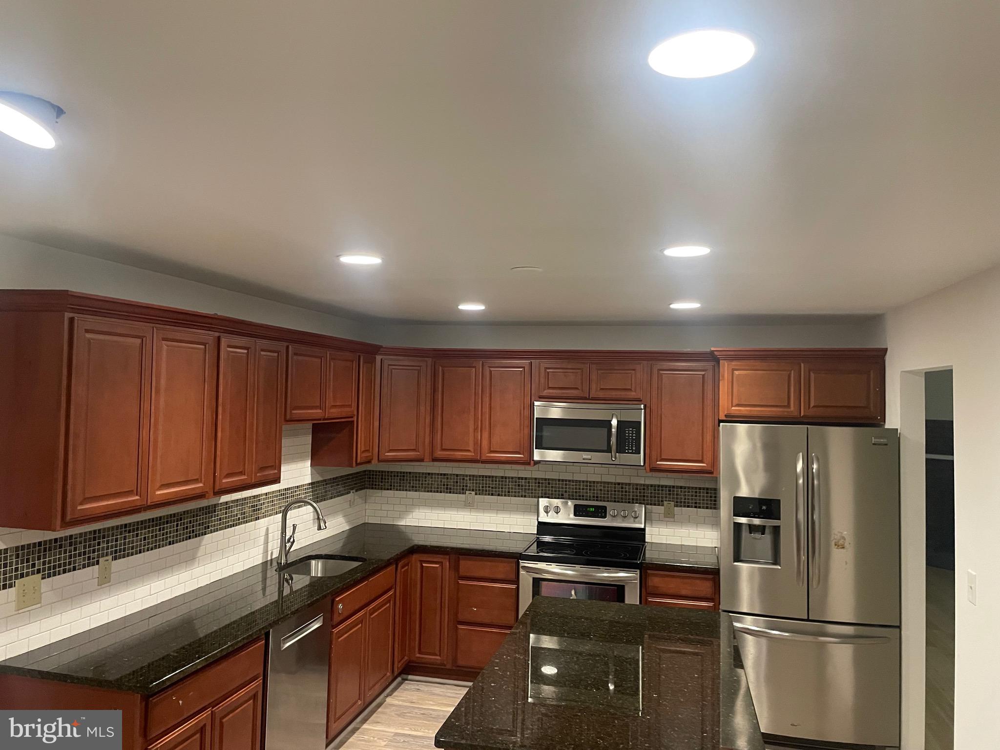 1300 Shadyside Road Downingtown, PA 19335 - Photo 8 of 17 a kitchen with stainless steel appliances granite countertop a refrigerator stove a sink and dishwasher