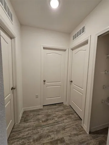a view of kitchen with kitchen island and stainless steel appliances