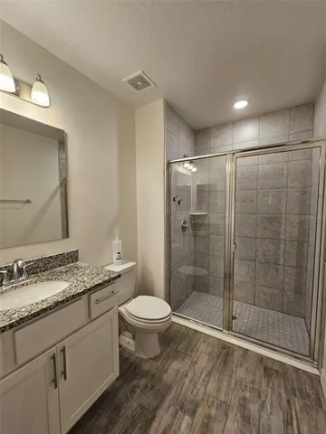 a white toilet sitting next to a bathroom sink