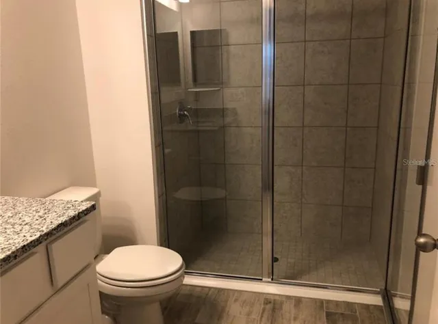 a bathroom with a shower and a toilet
