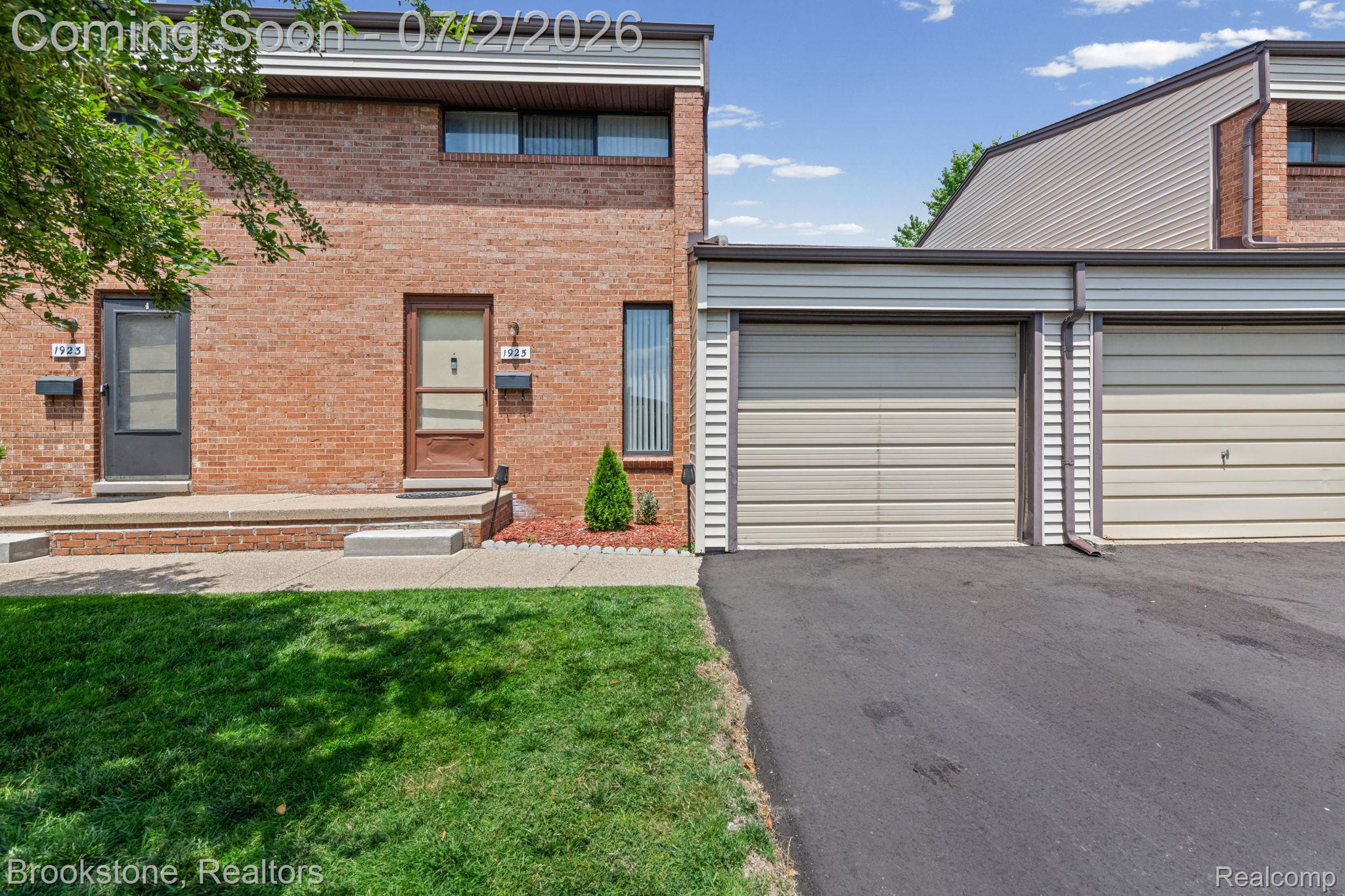 1925 Nicholas Court Warren, MI 48092 - Photo 2 of 26 Brick facade townhome with a private front entrance and an attached garage