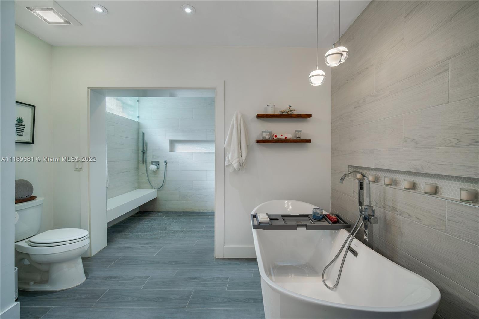 6465 Southwest 126th Street Road Pinecrest, FL 33156 - Photo 13 of 37 a bathroom with a granite countertop toilet a sink and a mirror