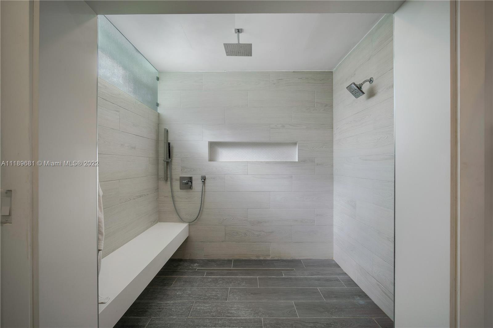 6465 Southwest 126th Street Road Pinecrest, FL 33156 - Photo 14 of 37 a bathroom with a glass shower door