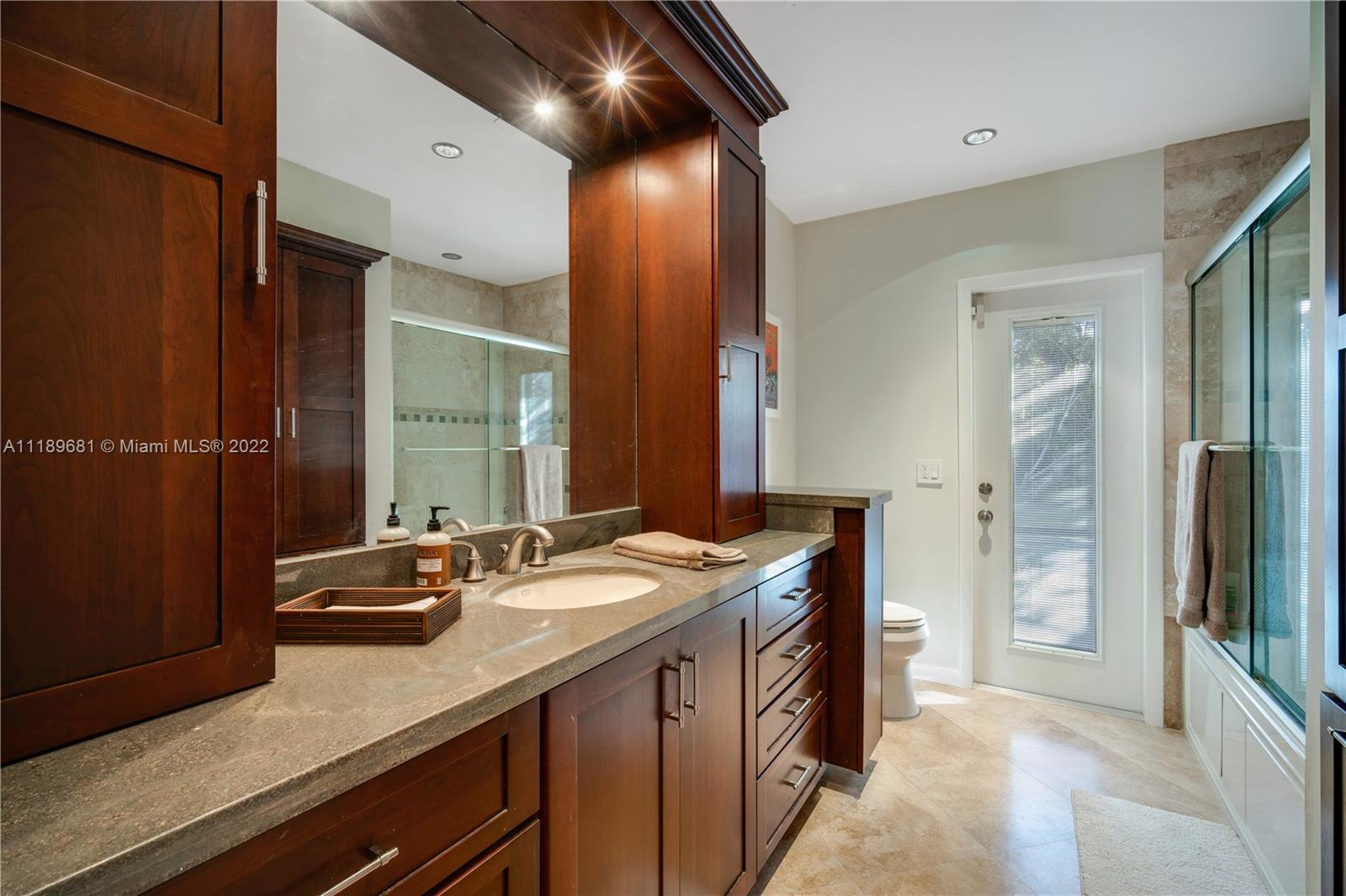 6465 Southwest 126th Street Road Pinecrest, FL 33156 - Photo 20 of 37 a bathroom with a sink double vanity and a mirror