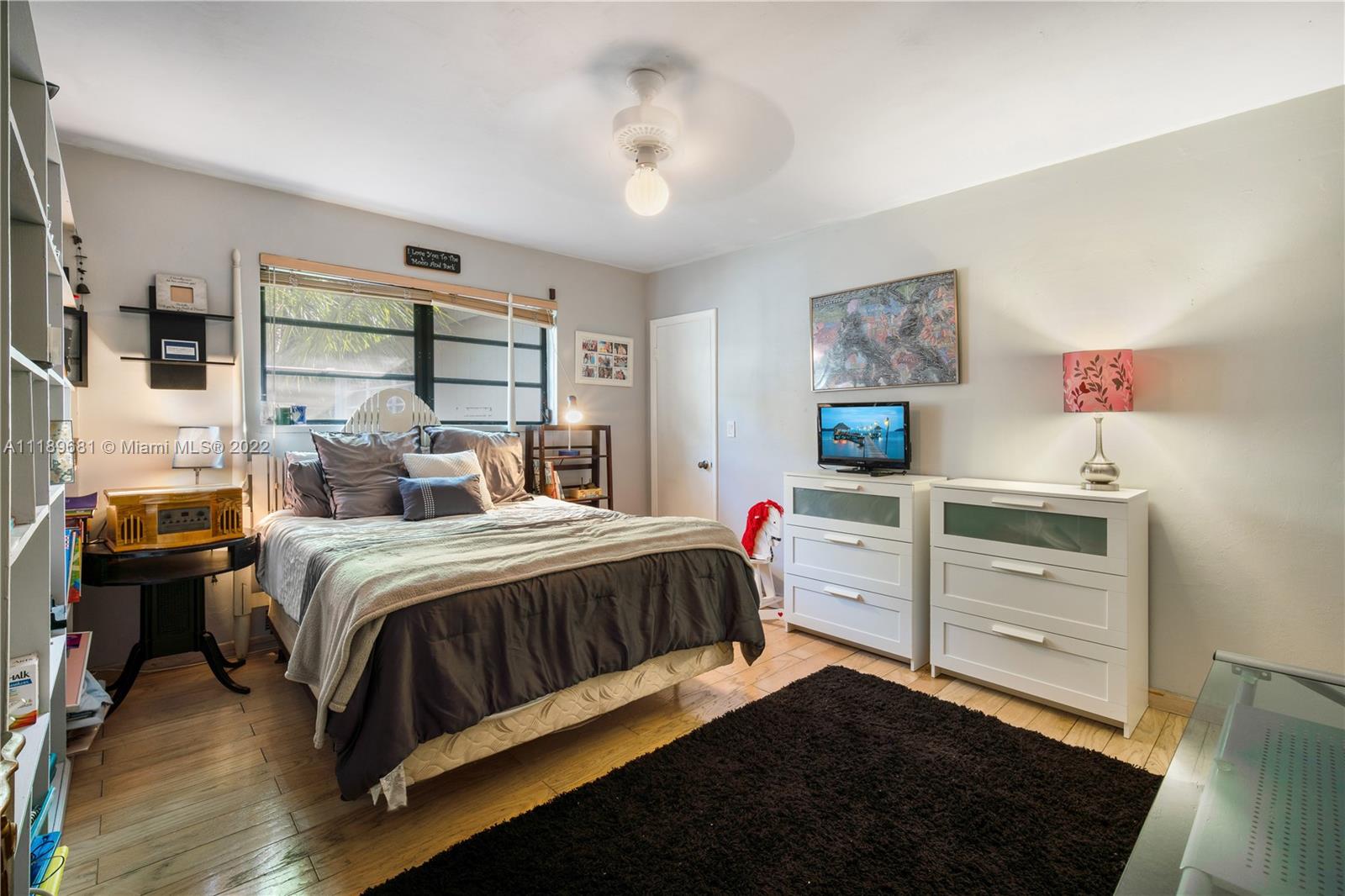 6465 Southwest 126th Street Road Pinecrest, FL 33156 - Photo 21 of 37 a bedroom with a bed and a window