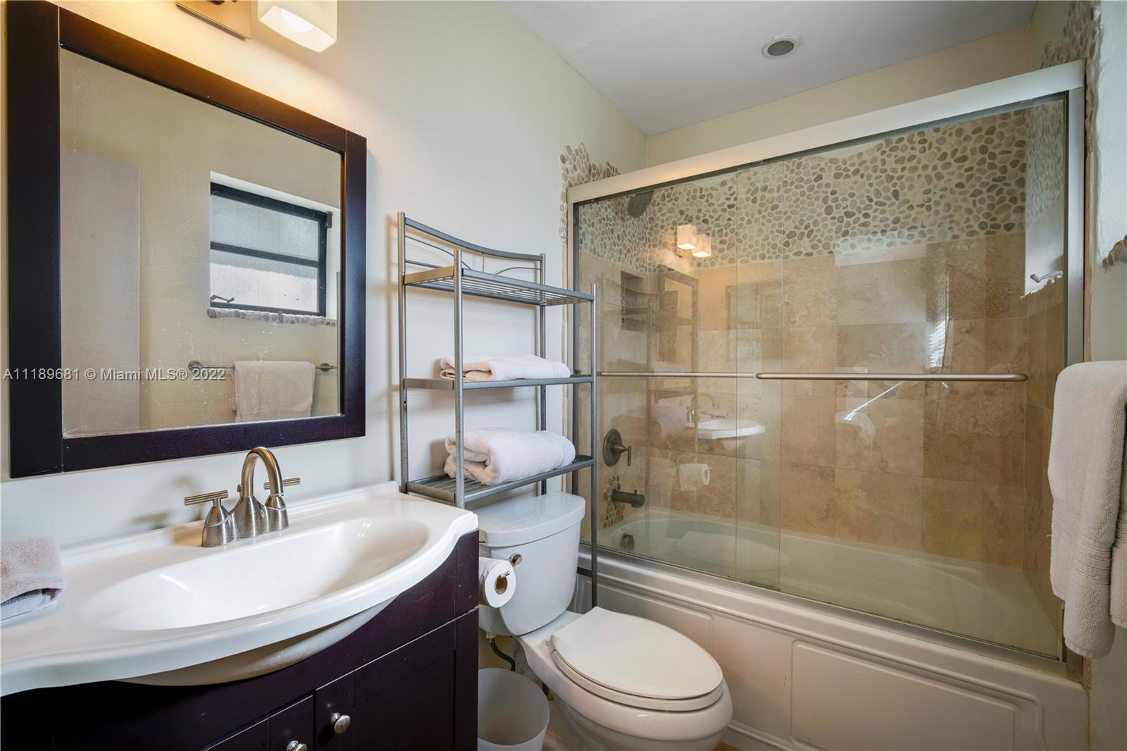 6465 Southwest 126th Street Road Pinecrest, FL 33156 - Photo 22 of 37 a bathroom with a sink toilet and shower