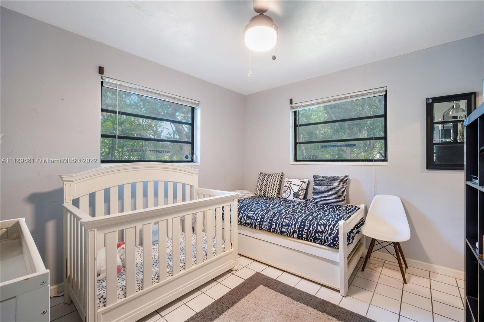6465 Southwest 126th Street Road Pinecrest, FL 33156 - Photo 23 of 37 a bedroom with furniture and a window
