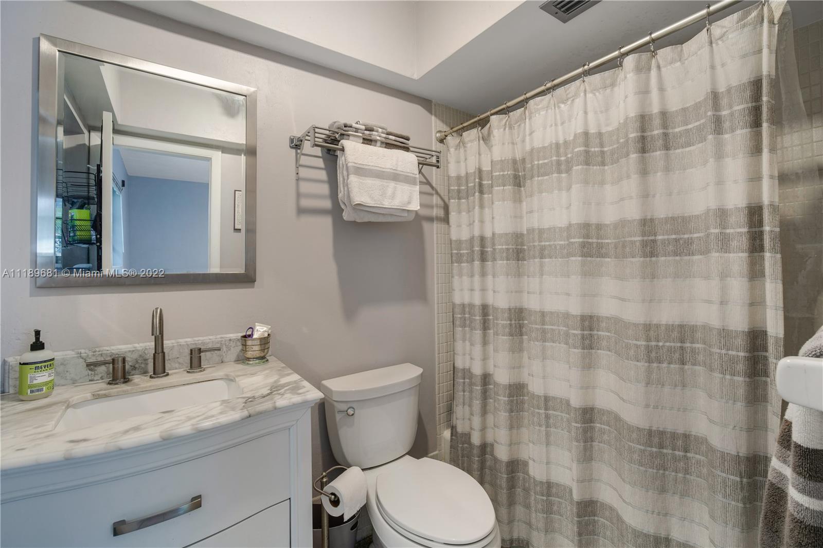 6465 Southwest 126th Street Road Pinecrest, FL 33156 - Photo 24 of 37 a bathroom with a granite countertop sink a toilet and shower
