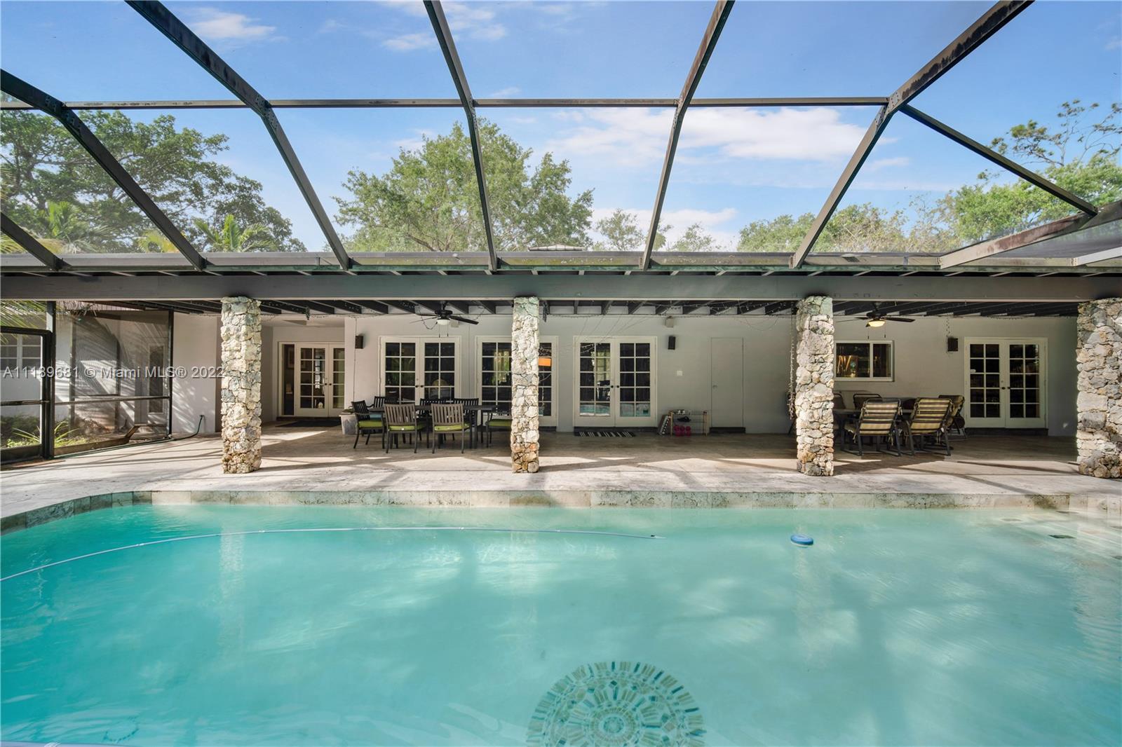 6465 Southwest 126th Street Road Pinecrest, FL 33156 - Photo 29 of 37 a backyard of a house with yard and outdoor seating