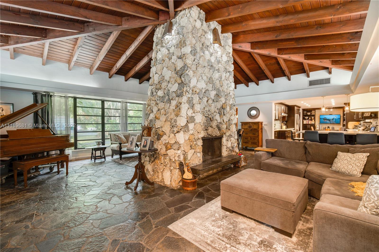 6465 Southwest 126th Street Road Pinecrest, FL 33156 - Photo 35 of 37 a living room with furniture and a fireplace