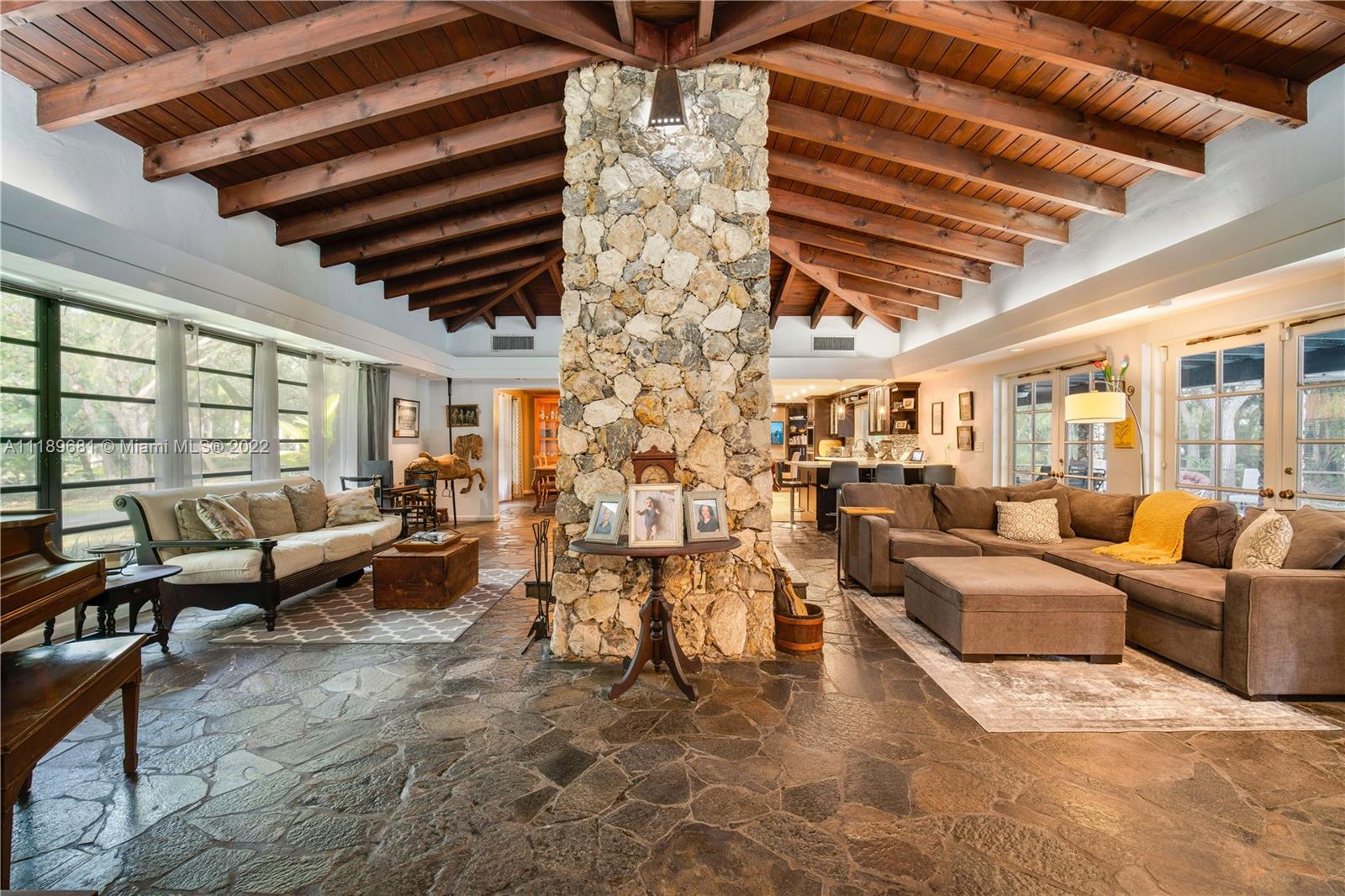 6465 Southwest 126th Street Road Pinecrest, FL 33156 - Photo 7 of 37 a living room with lots of furniture and a chandelier