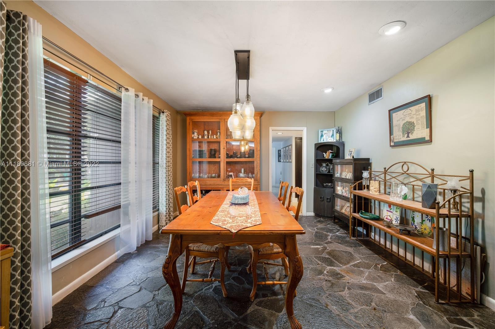 6465 Southwest 126th Street Road Pinecrest, FL 33156 - Photo 10 of 37 a dining room with furniture large windows and wooden floor