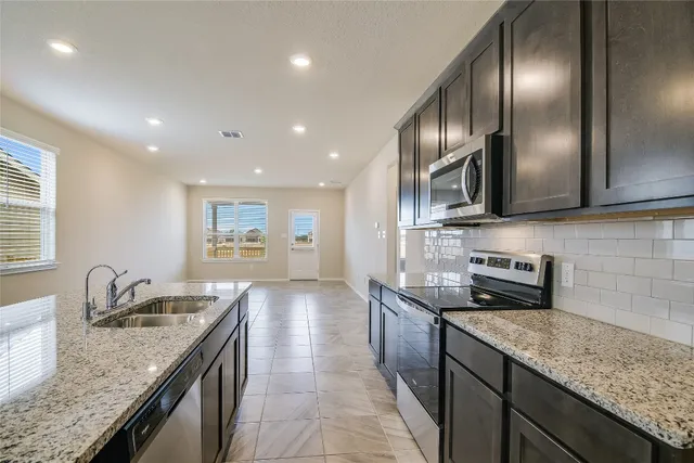 a kitchen with granite countertop stainless steel appliances lots of counter top space