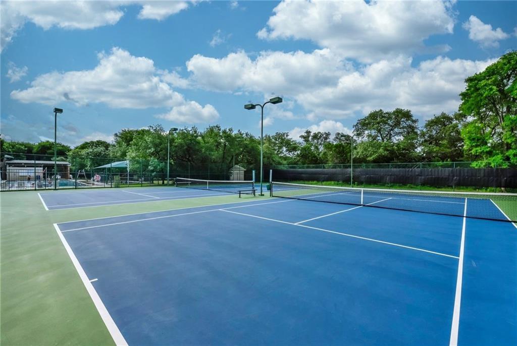 4404 Travis Country Circle, Unit G4 Austin, TX 78735 - Photo 12 of 15 Sporting amenities include two well-maintained tennis courts and an inviting pool area, perfect for recreation.