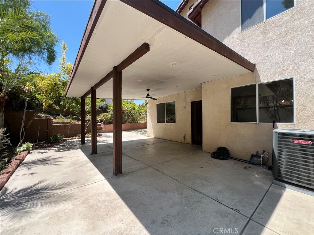 16200 Setting Sun Circle Riverside, CA 92503 - Photo 17 of 20 a view of a porch with chairs and potted plants
