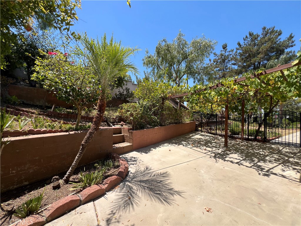 16200 Setting Sun Circle Riverside, CA 92503 - Photo 19 of 20 a view of backyard with a table and chair and barbeque grill