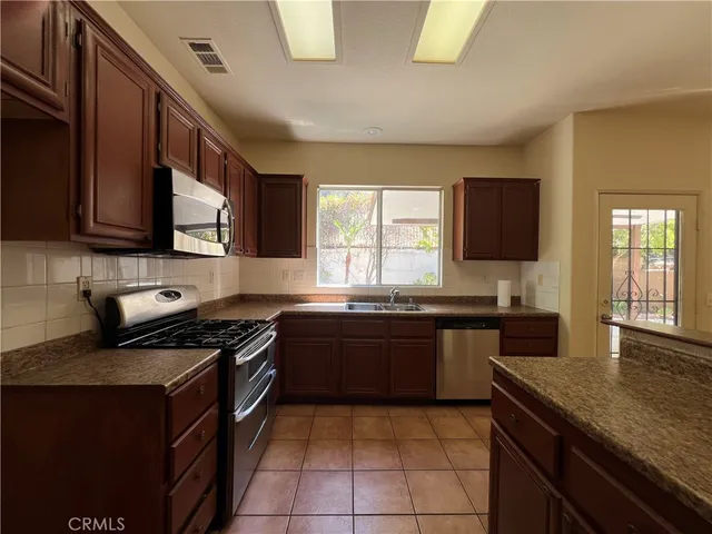 a kitchen with a stove a sink and a microwave