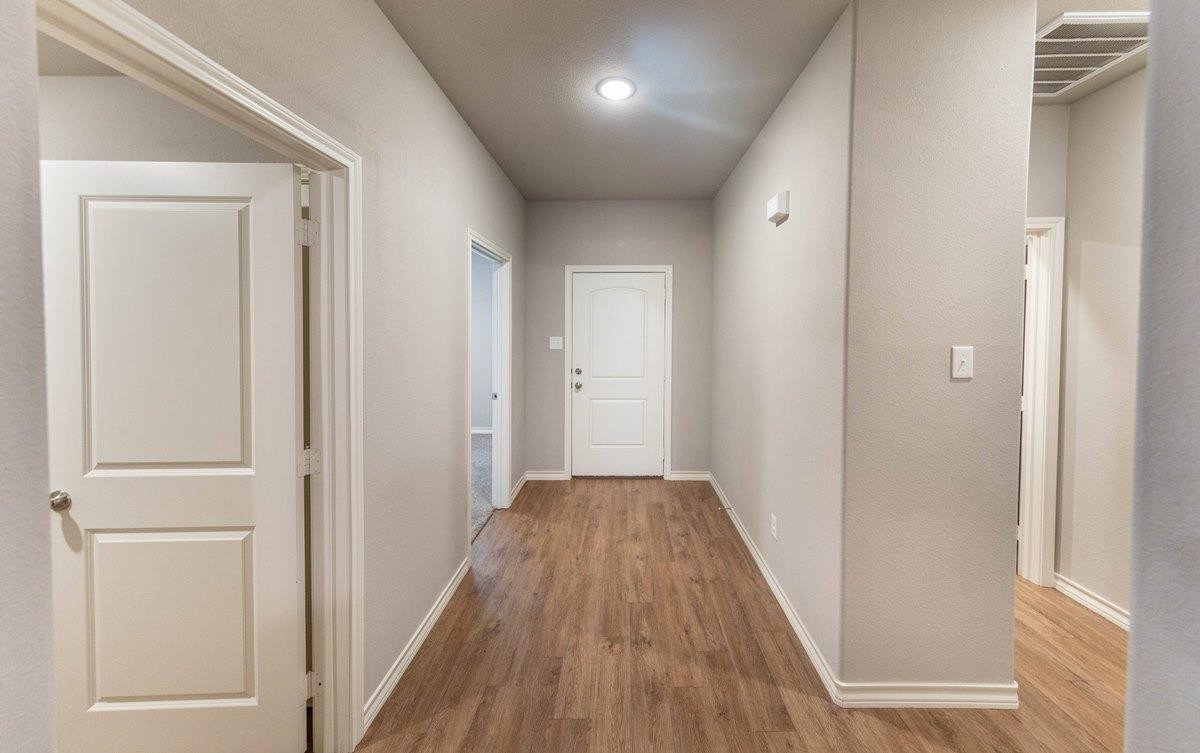 2545 137th Street Lubbock, TX 79423 - Photo 17 of 26 a view of a hallway with wooden floor