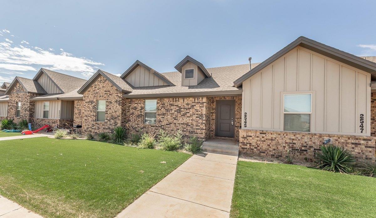 2545 137th Street Lubbock, TX 79423 - Photo 20 of 26 a front view of a house with a yard and garage