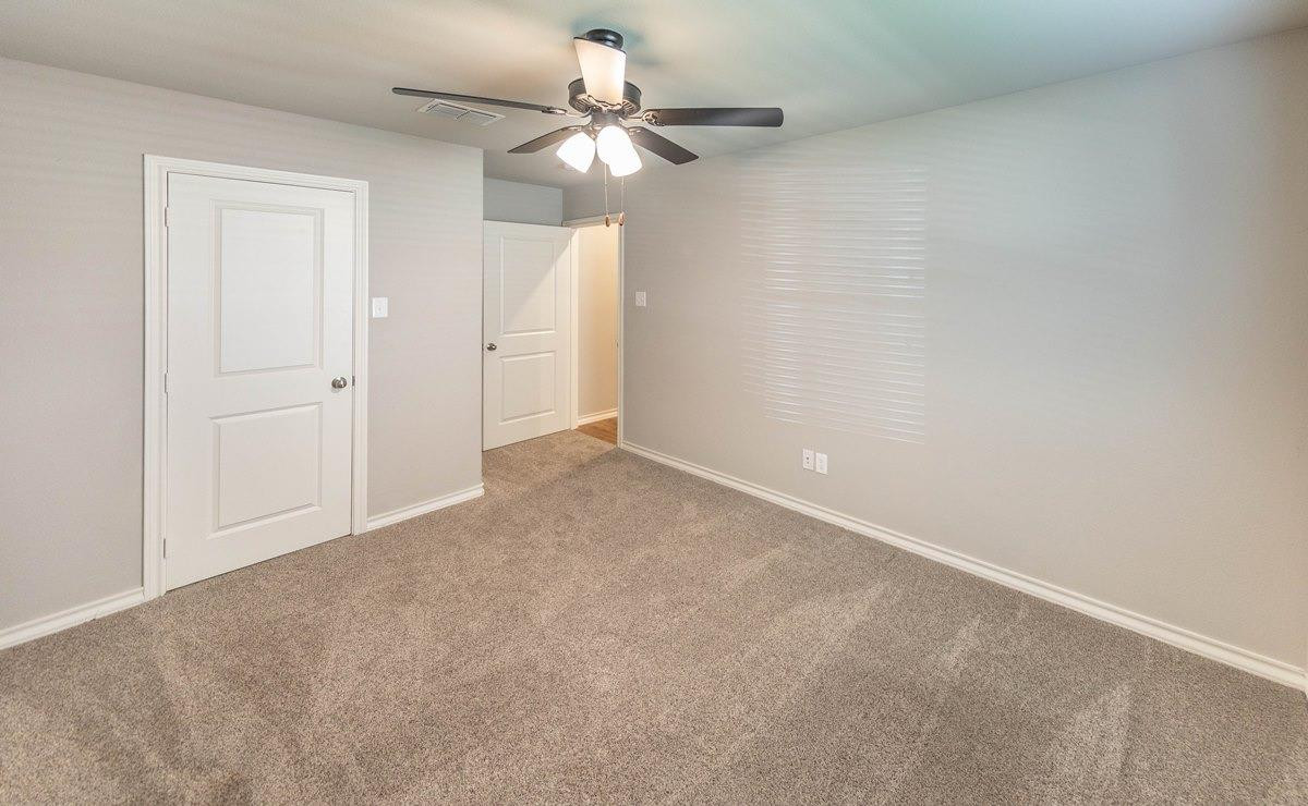 2545 137th Street Lubbock, TX 79423 - Photo 6 of 26 an empty room with a chandelier fan and closet area