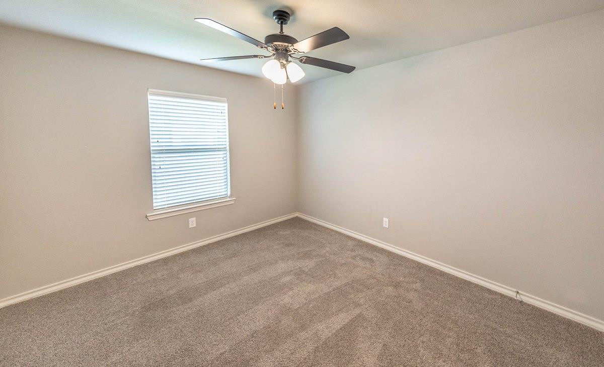 2545 137th Street Lubbock, TX 79423 - Photo 9 of 26 an empty room with a window and a fan