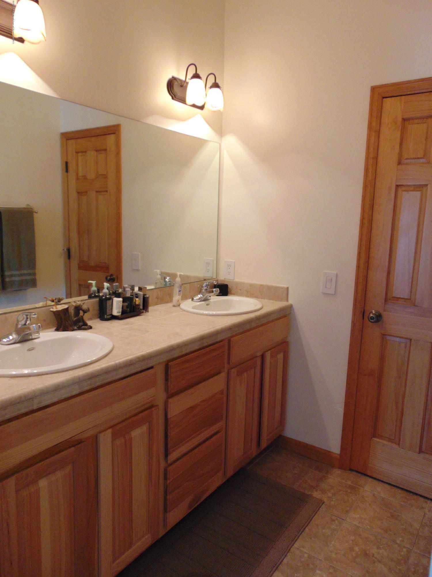 1282 East 17th Street Rifle, CO 81650 - Photo 19 of 25 a bathroom with a double vanity sink and a mirror