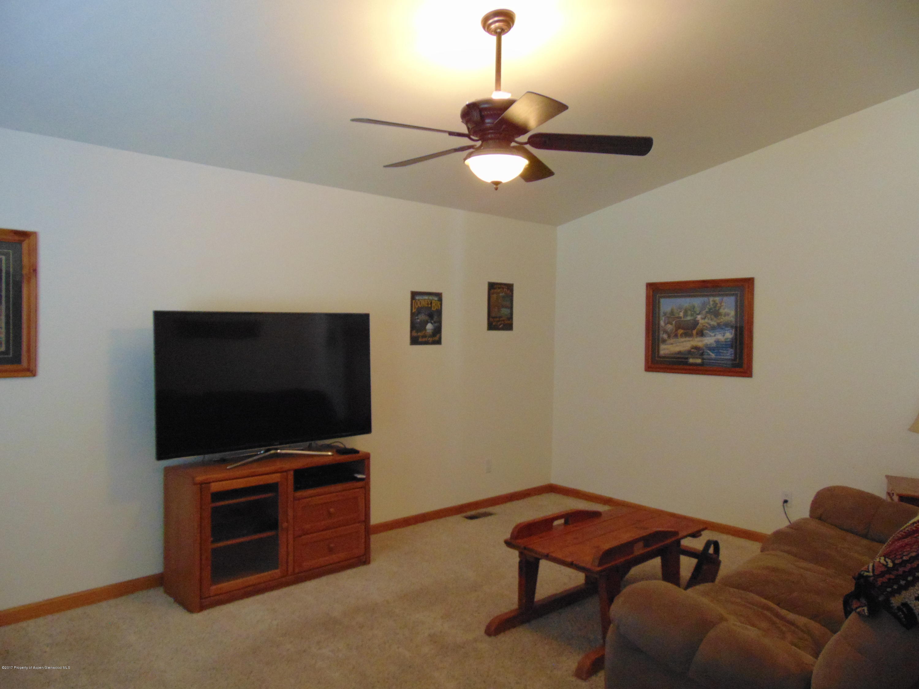 1282 East 17th Street Rifle, CO 81650 - Photo 5 of 25 a living room with furniture and a flat screen tv