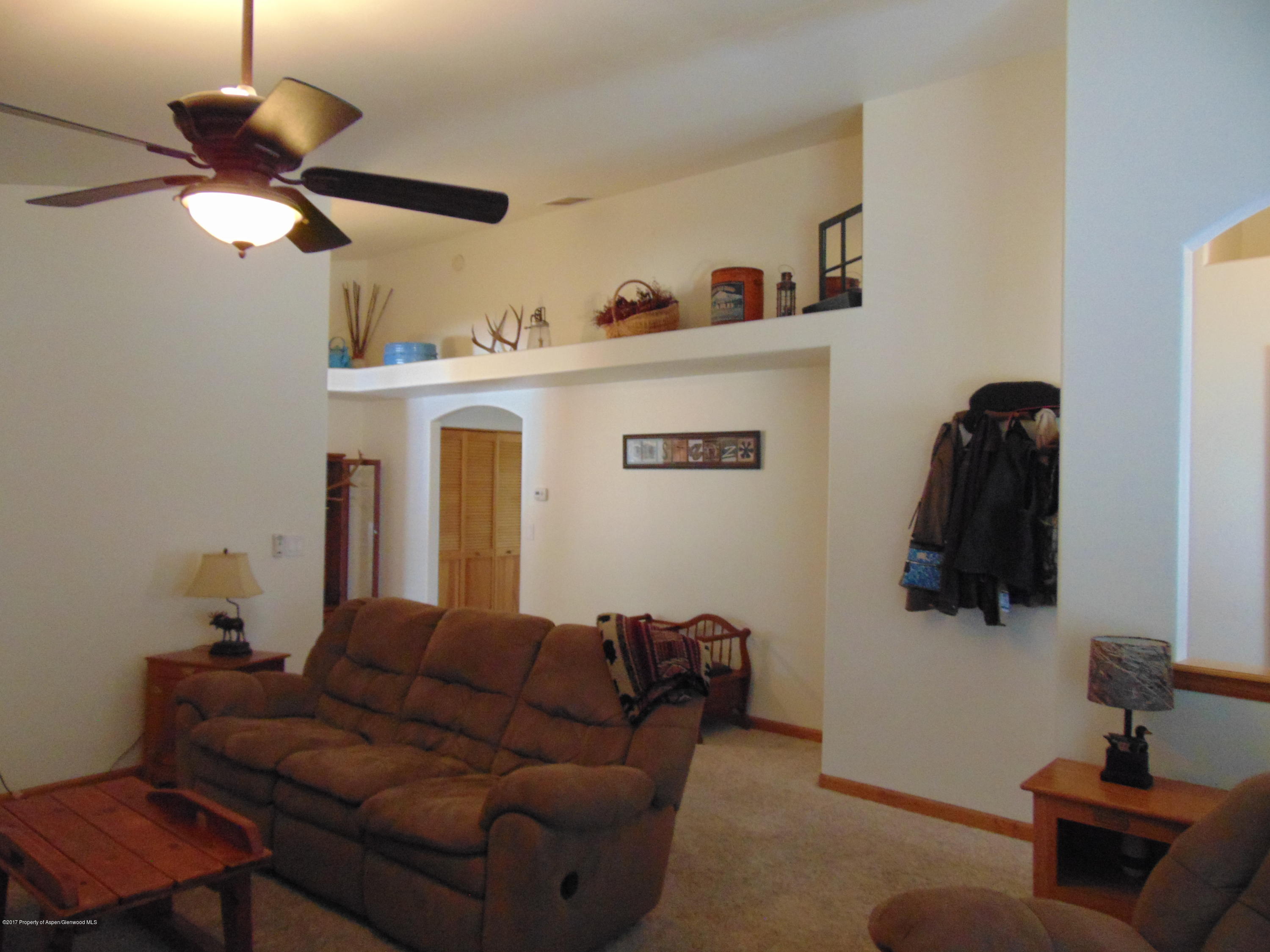 1282 East 17th Street Rifle, CO 81650 - Photo 8 of 25 a living room with furniture and a flat screen tv