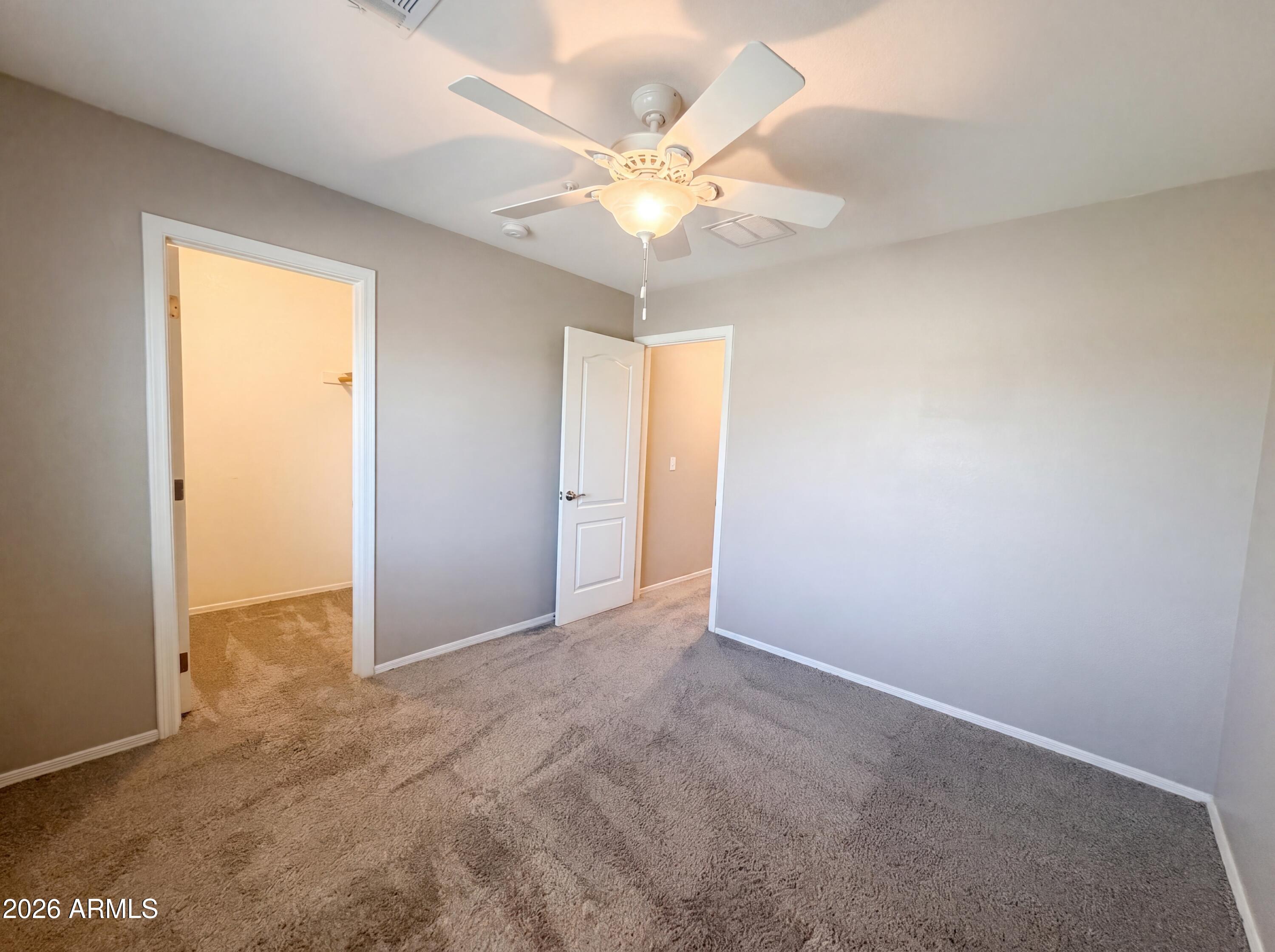1565 East Hopkins Road Gilbert, AZ 85295 - Photo 13 of 29 an empty room with closet and a chandelier fan
