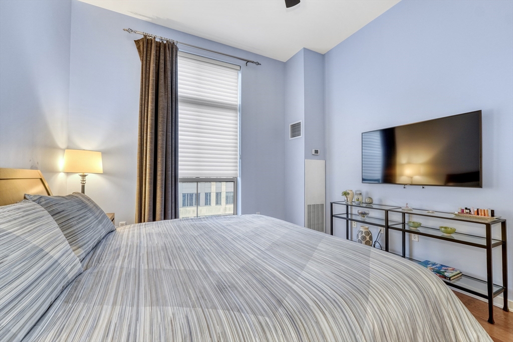 2 Rollins Street, Unit D603 Boston, MA 02118 - Photo 16 of 20 a bedroom with a bed and a flat screen tv