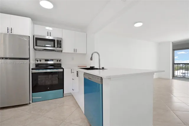 a kitchen with a sink a stove and refrigerator