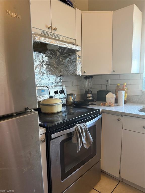 2531 47th Terrace Southwest Naples, FL 34116 - Photo 12 of 17 a kitchen with granite countertop a sink stove and cabinets