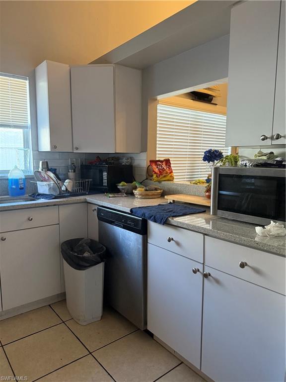 2531 47th Terrace Southwest Naples, FL 34116 - Photo 13 of 17 a kitchen with a sink and a stove top oven