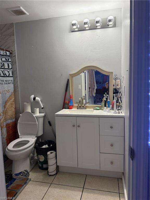 2531 47th Terrace Southwest Naples, FL 34116 - Photo 15 of 17 a bathroom with a toilet sink and mirror