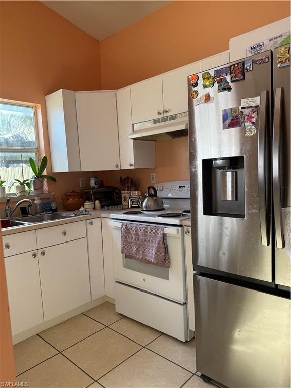 2531 47th Terrace Southwest Naples, FL 34116 - Photo 4 of 17 a kitchen with stainless steel appliances a refrigerator sink and cabinets